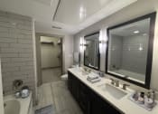 Thumbnail 32 of 33 - a bathroom with two sinks and a large mirror