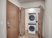 Thumbnail 7 of 23 - a small laundry room with a washing machine and a dryer