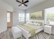 Thumbnail 65 of 65 - a bedroom with a large bed and a ceiling fan