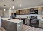 Thumbnail 8 of 23 - a kitchen with wooden cabinets and a white counter top
