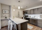 Thumbnail 9 of 23 - a kitchen with a white counter top and wooden cabinets