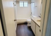 Thumbnail 18 of 36 - an empty bathroom with a toilet and a sink