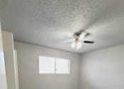 Thumbnail 16 of 36 - an empty living room with wood floors and a ceiling fan