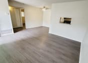 Thumbnail 12 of 36 - an empty living room and dining room with wood flooring