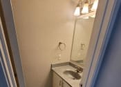 Thumbnail 27 of 36 - a bathroom with a sink and a mirror