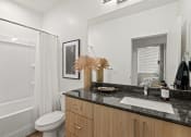 Thumbnail 7 of 30 - a bathroom with a sink and a mirror and a toilet