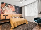 Thumbnail 10 of 30 - a bedroom with a bed and a large painting of flowers