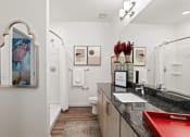 Thumbnail 13 of 30 - a bathroom with a sink and a mirror and a toilet