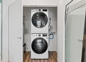 Thumbnail 15 of 30 - a white washer and dryer in a white laundry room