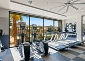 Thumbnail 20 of 30 - a gym with floor to ceiling windows and cardio equipment