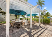 Thumbnail 25 of 41 - a patio with tables and chairs and umbrellas