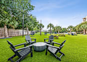Thumbnail 35 of 42 - A lawn with chairs and a table in the middle.