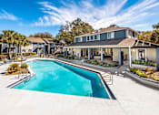 Thumbnail 3 of 35 - A swimming pool in front of a house.