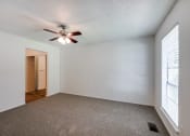 Thumbnail 22 of 25 - the living room of an empty house with a ceiling fan
