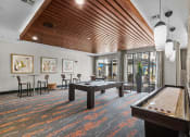 Thumbnail 5 of 25 - a spacious game room with a pool table and a bar