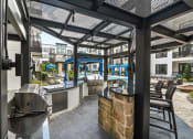 Thumbnail 17 of 25 - a patio with a bar and tables and a pool