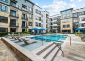 Thumbnail 15 of 25 - a swimming pool in front of an apartment building