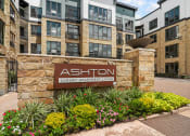 Thumbnail 24 of 25 - an exterior view of an apartment building with a sign luxury apartment living