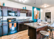 Thumbnail 2 of 52 - a kitchen with black appliances and a granite countertop