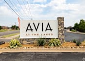 Thumbnail 52 of 52 - ava at the lakes monument sign on the side of a road