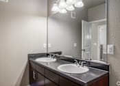 Thumbnail 11 of 52 - an empty bathroom with two sinks and a large mirror
