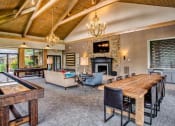 Thumbnail 8 of 25 - a large living room with a large wooden table and a fireplace