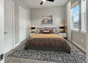Thumbnail 17 of 30 - a bedroom with a bed and a ceiling fan