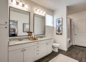 Thumbnail 5 of 17 - a bathroom with two mirrors and a toilet