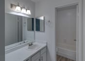 Thumbnail 5 of 19 - a bathroom with a sink and a mirror and a shower