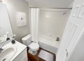Thumbnail 7 of 29 - a bathroom with a shower toilet and sink