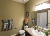 Thumbnail 4 of 15 - a bathroom with a sink toilet and a mirror