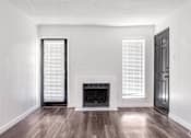 Thumbnail 22 of 66 - an empty living room with white walls and a fireplace