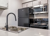 Thumbnail 20 of 66 - a kitchen with a sink and a refrigerator