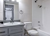 Thumbnail 25 of 66 - a bathroom with a sink toilet and tub and a mirror
