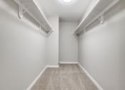 Thumbnail 7 of 24 - a empty room with white walls and a carpeted floor