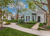 Thumbnail 1 of 24 - a small green house with a sidewalk in front of it