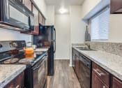 Thumbnail 10 of 24 - a kitchen with stainless steel appliances and marble counter tops