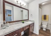 Thumbnail 12 of 24 - a bathroom with a large mirror and a sink