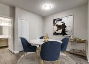 Thumbnail 5 of 24 - a dining room with a marble table and blue chairs