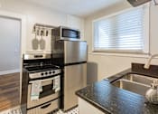 Thumbnail 4 of 23 - A kitchen with a black and white checkered floor.