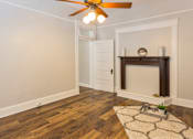 Thumbnail 7 of 23 - A room with a fireplace and a rug on the floor.