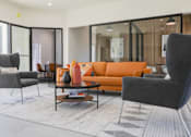 Thumbnail 15 of 66 - a living room with a orange couch and chairs