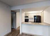 Thumbnail 2 of 66 - a kitchen with a counter top and a black refrigerator