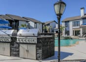 Thumbnail 13 of 66 - a group of barbecue grills next to a swimming pool