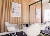 Thumbnail 18 of 66 - a conference room with white chairs and a glass table
