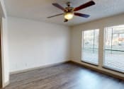 Thumbnail 7 of 66 - an empty living room with a ceiling fan and a window