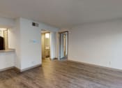 Thumbnail 5 of 66 - an empty living room with white walls and wood floors