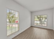 Thumbnail 9 of 24 - the living room of an apartment with wood floors and a large window