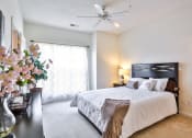 Thumbnail 29 of 29 - a bedroom with a large bed and a ceiling fan
