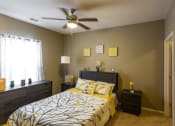 Thumbnail 3 of 15 - a bedroom with a bed and a ceiling fan